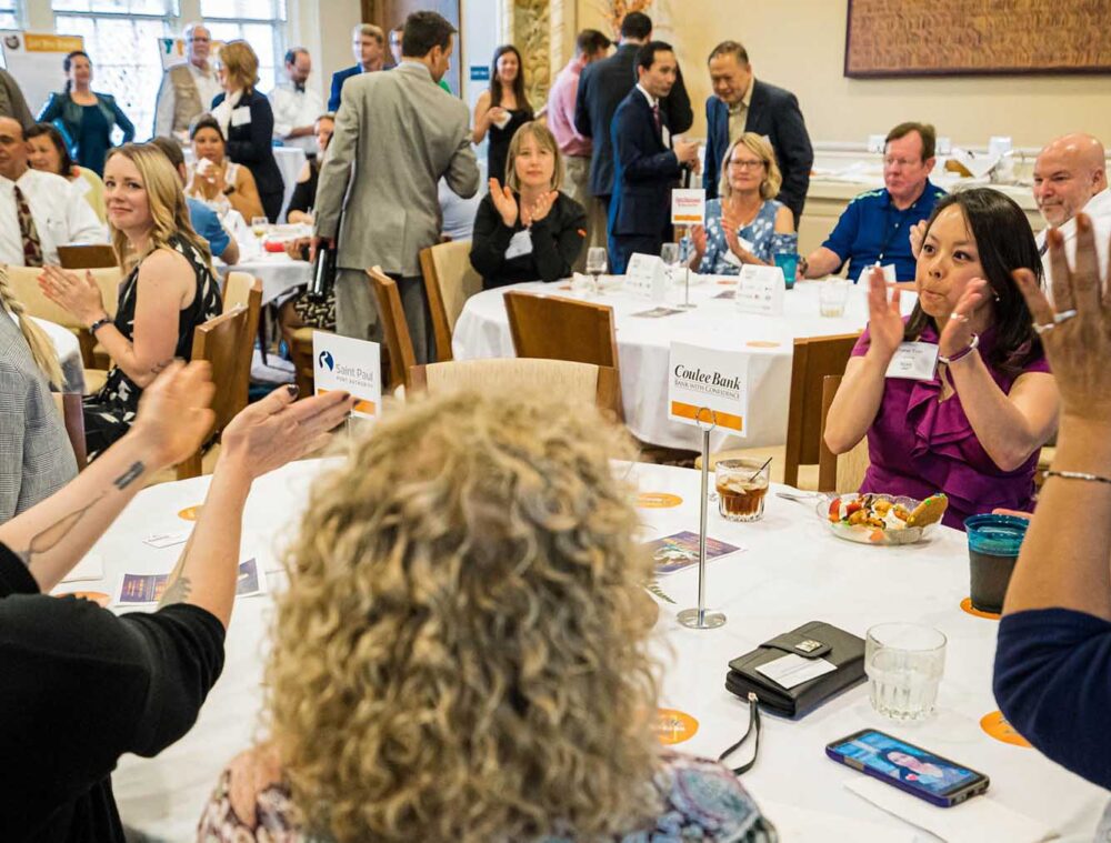 Participants in a large crowd applaud for a presentation in The Commons at the Minnesota Humanities Event Center in St. Paul.