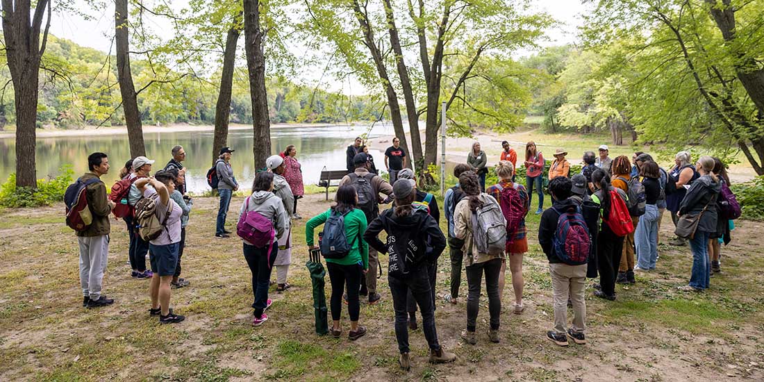 Participants at a Learning from Place: Bdote listen as a presenter discusses the importance of this land to the Dakota people.