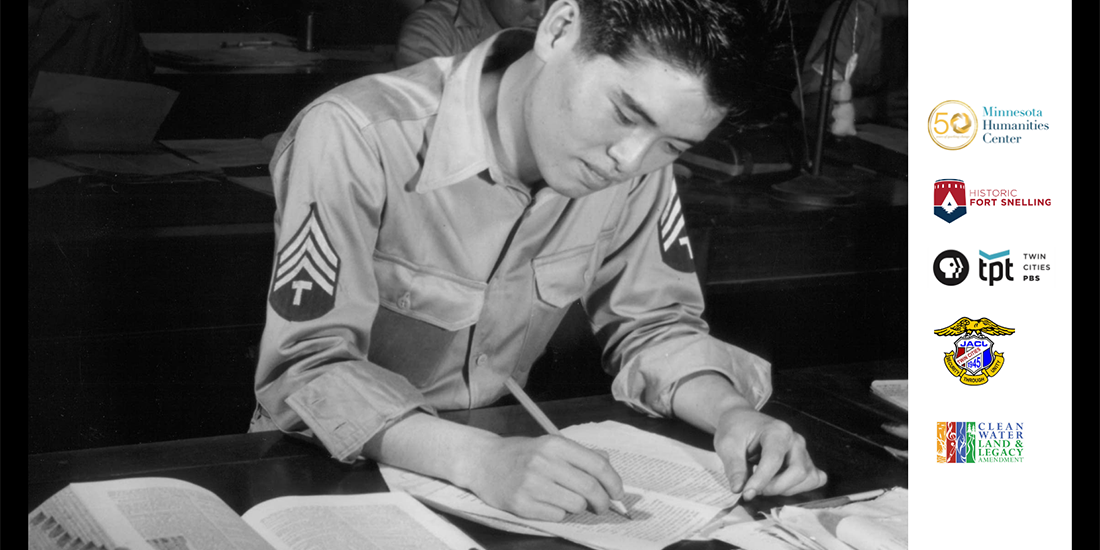 A Japanese-American member of the U.S. Army looks over paperwork.