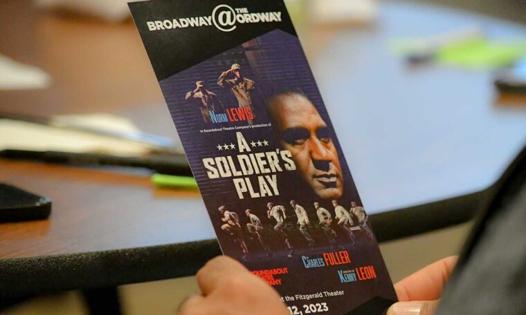 A member of the Black Vision Trust holds a program from the performance of "A Solider's Play" by Charles Fuller.